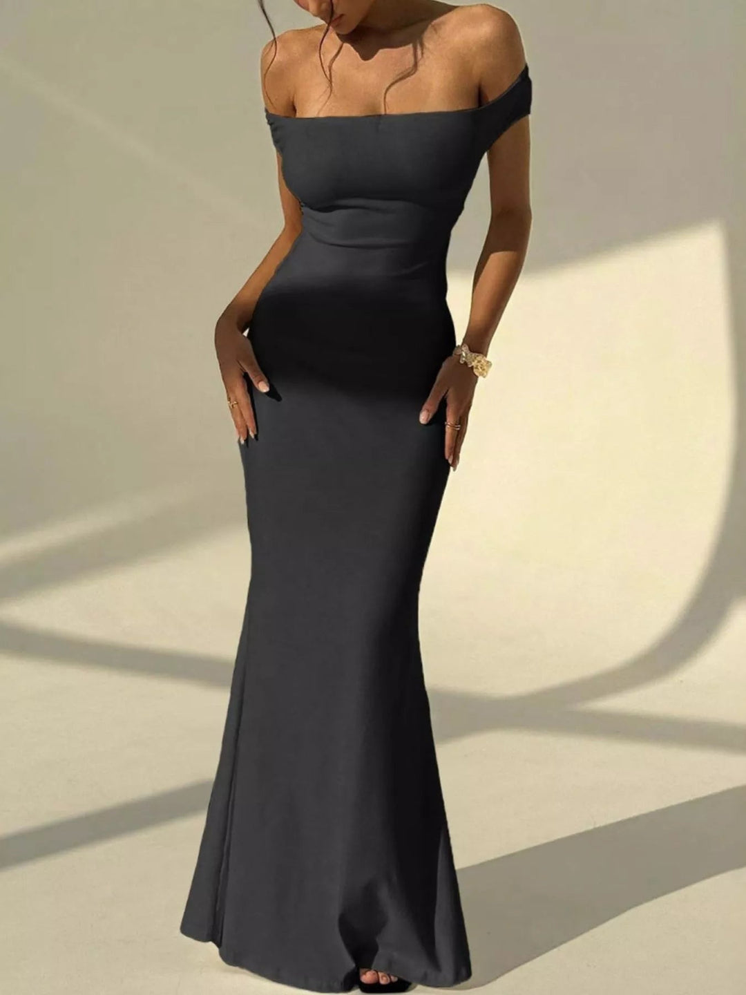 Backless Off-Shoulder Mermaid Dress featuring open back detail, fitted bodycon silhouette, elegant off-shoulder neckline, and floor-length flared hem.