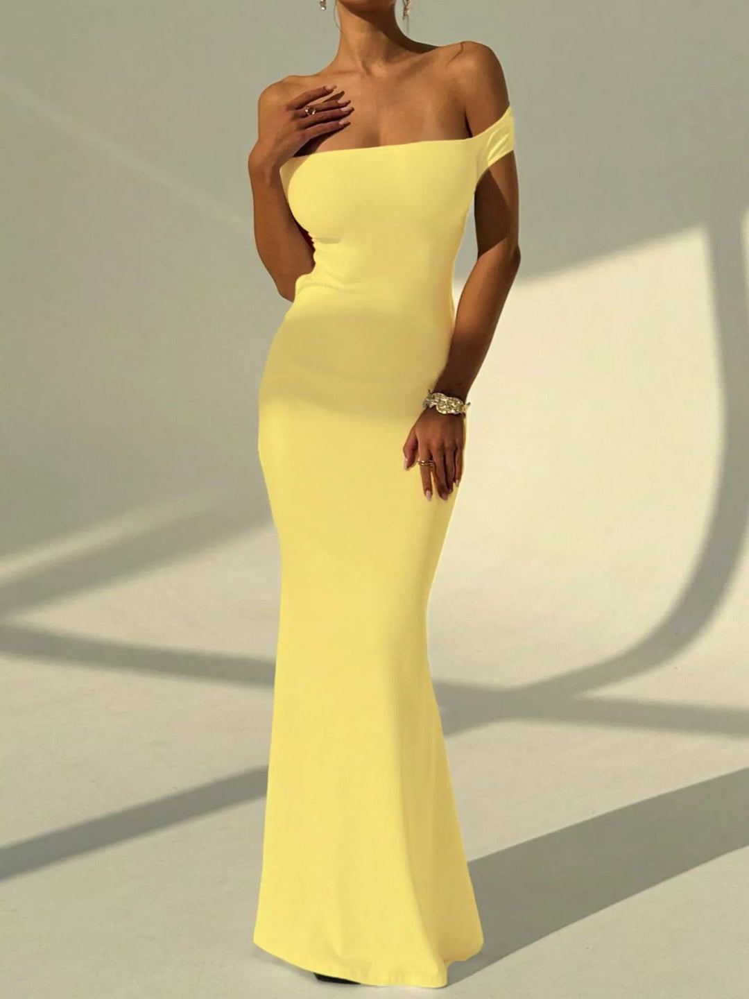 Backless Off-Shoulder Mermaid Dress featuring open back detail, fitted bodycon silhouette, elegant off-shoulder neckline, and floor-length flared hem.
