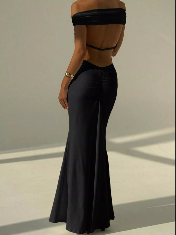 Backless Off-Shoulder Mermaid Dress featuring open back detail, fitted bodycon silhouette, elegant off-shoulder neckline, and floor-length flared hem.