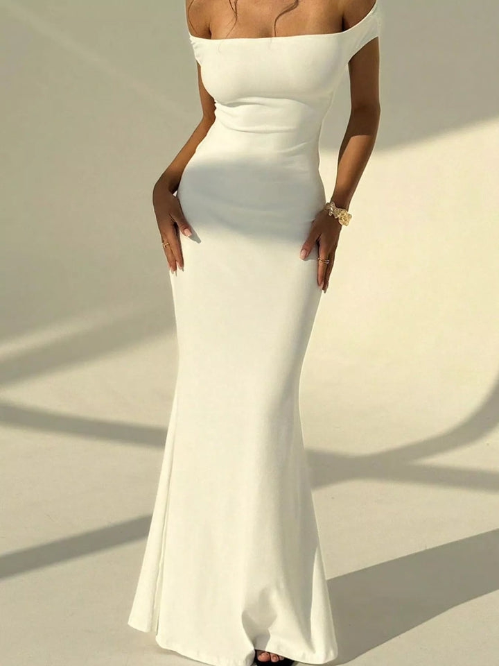 Backless Off-Shoulder Mermaid Dress featuring open back detail, fitted bodycon silhouette, elegant off-shoulder neckline, and floor-length flared hem.