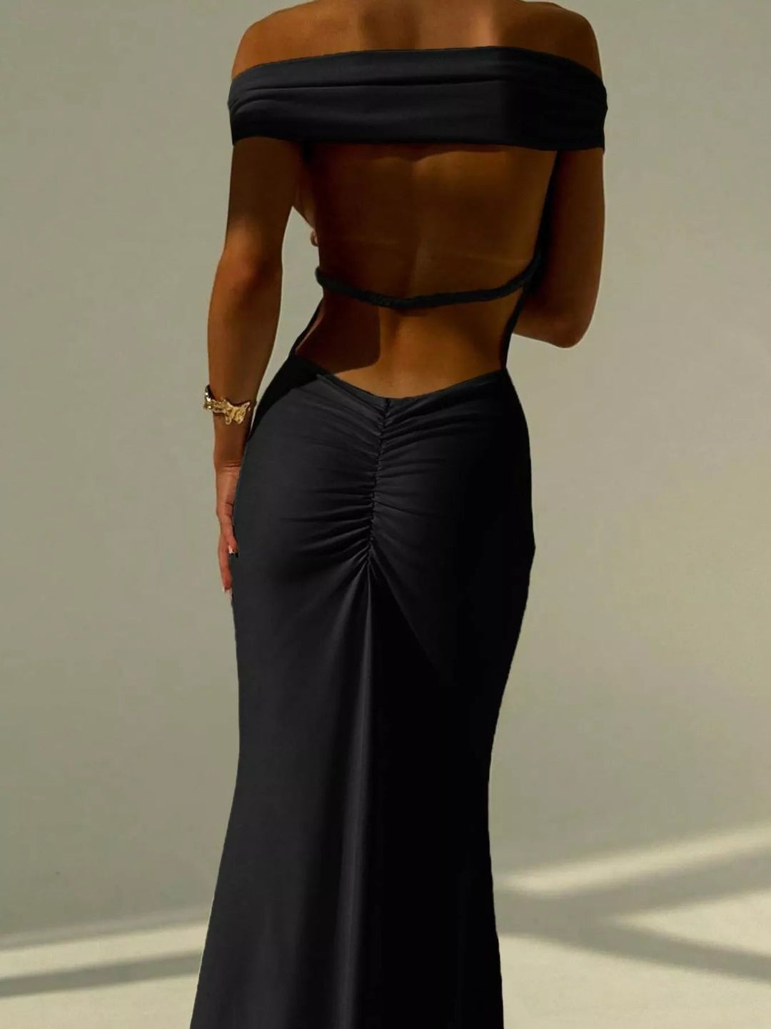Backless Off-Shoulder Mermaid Dress featuring open back detail, fitted bodycon silhouette, elegant off-shoulder neckline, and floor-length flared hem.