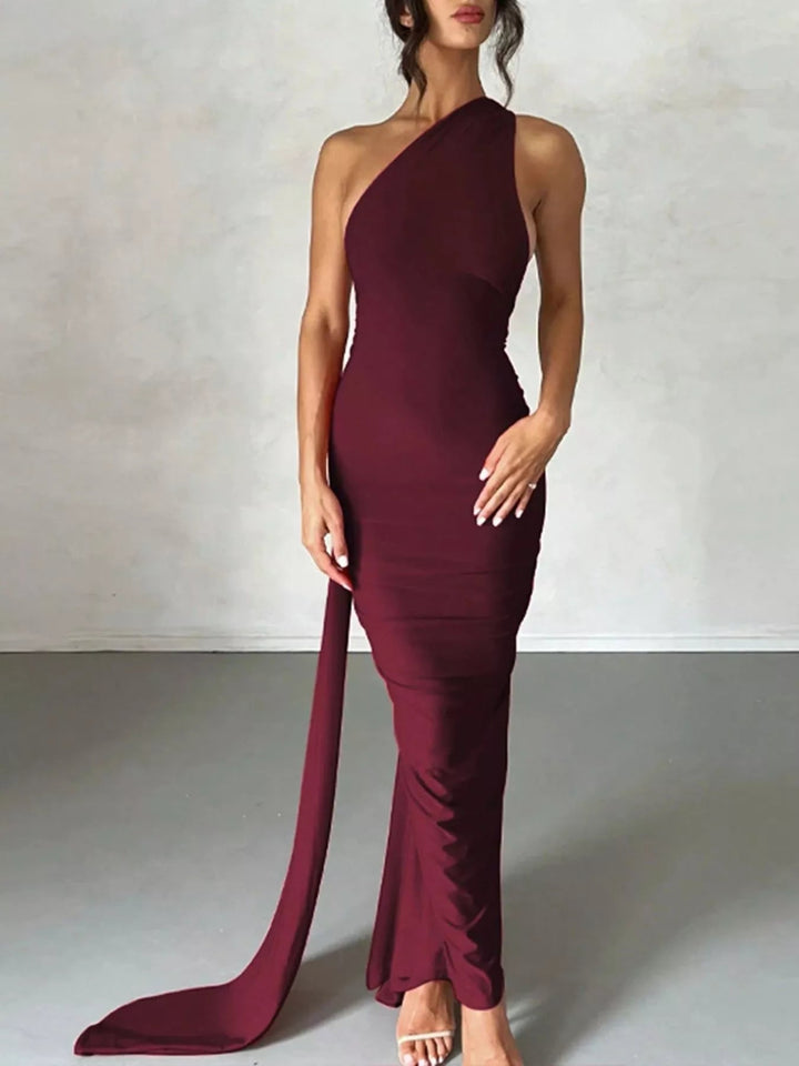 Backless One-Shoulder Bodycon Dress with ruched detailing, asymmetrical neckline, open back design, and elegant floor-length fitted silhouette.