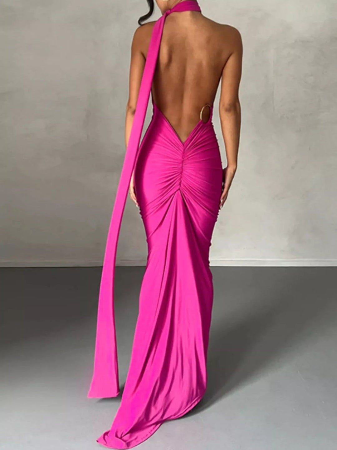 Backless One-Shoulder Bodycon Dress with ruched detailing, asymmetrical neckline, open back design, and elegant floor-length fitted silhouette.