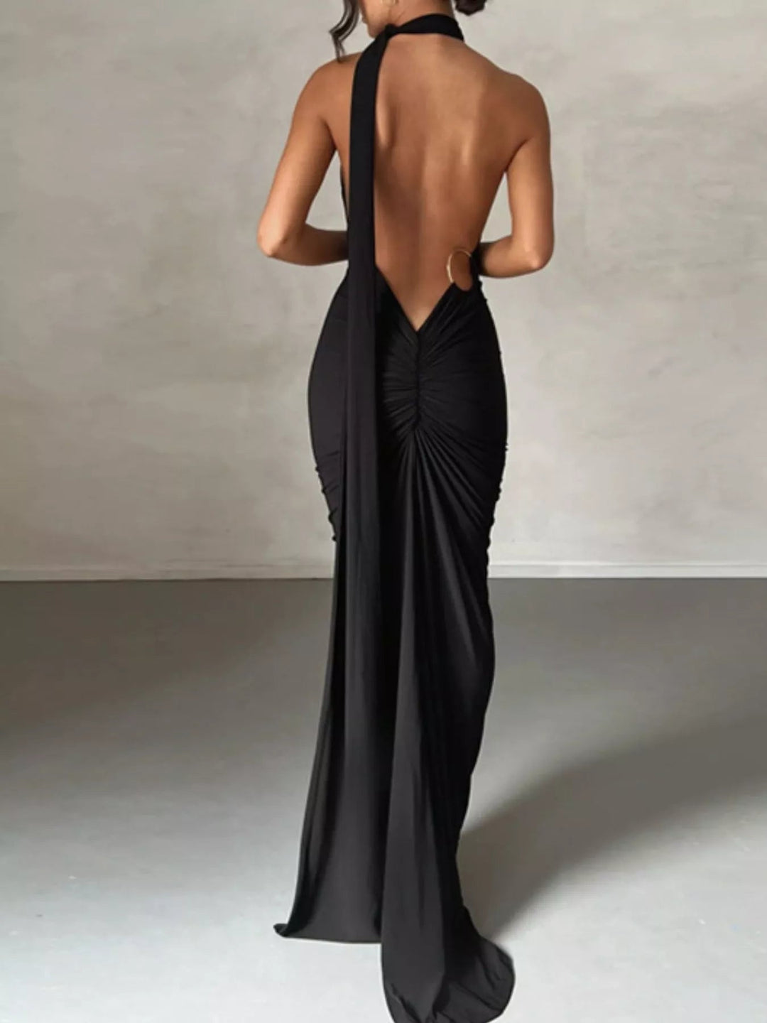Backless One-Shoulder Bodycon Dress with ruched detailing, asymmetrical neckline, open back design, and elegant floor-length fitted silhouette.
