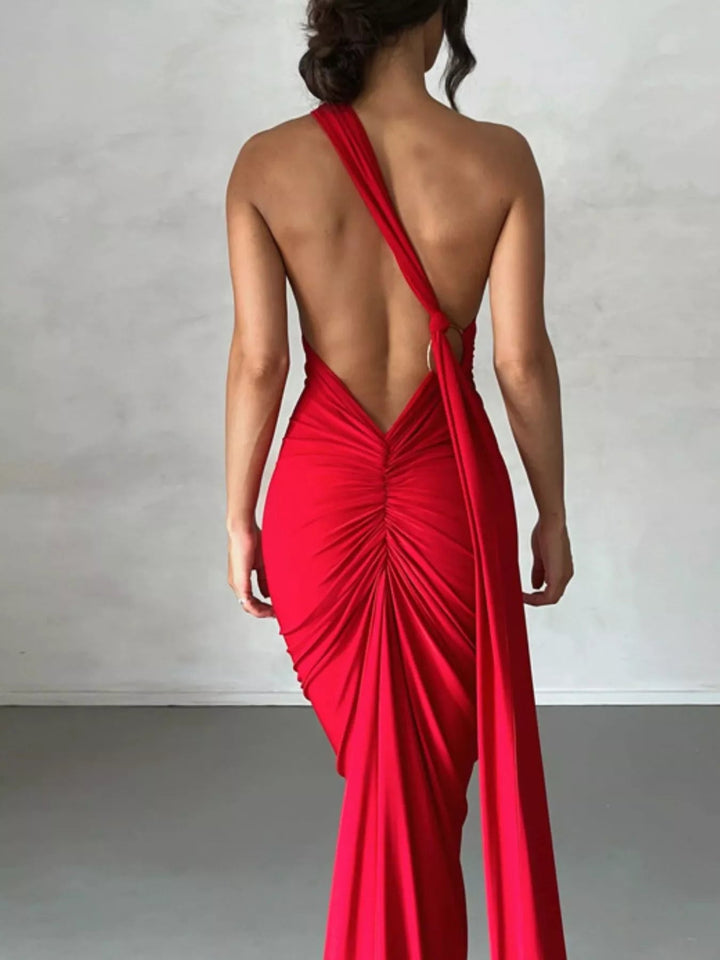 Backless One-Shoulder Bodycon Dress with ruched detailing, asymmetrical neckline, open back design, and elegant floor-length fitted silhouette.