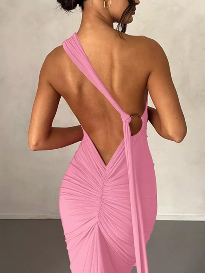 Backless One-Shoulder Bodycon Dress with ruched detailing, asymmetrical neckline, open back design, and elegant floor-length fitted silhouette.
