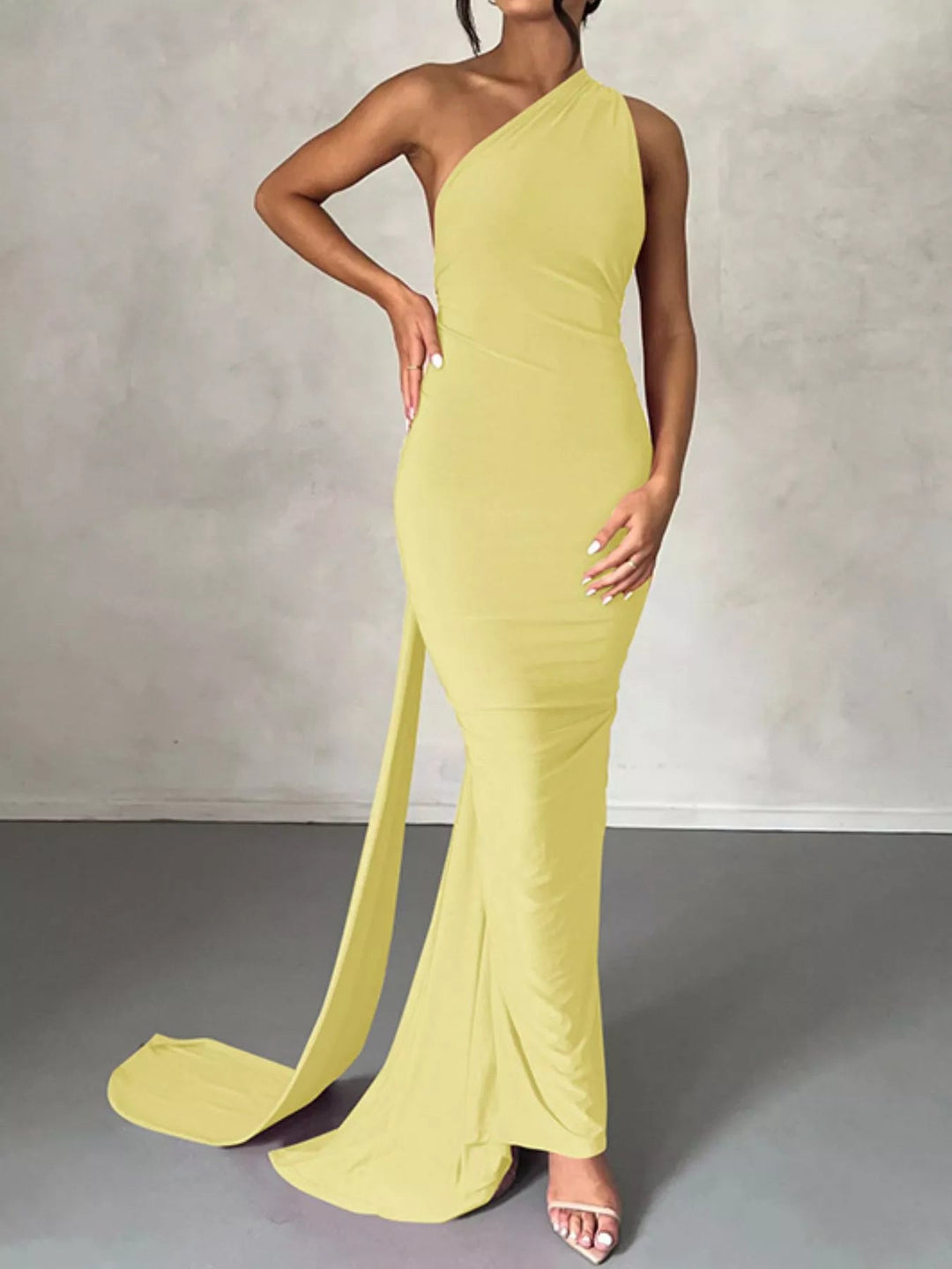 Backless One-Shoulder Bodycon Dress with ruched detailing, asymmetrical neckline, open back design, and elegant floor-length fitted silhouette.
