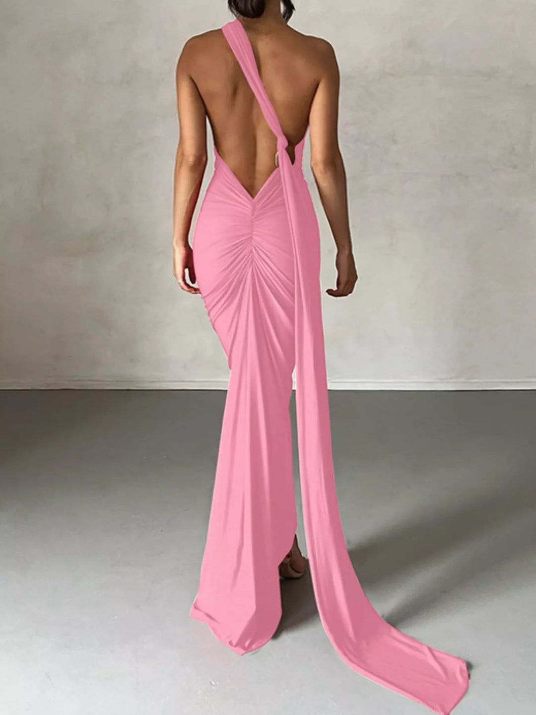 Backless One-Shoulder Bodycon Dress with ruched detailing, asymmetrical neckline, open back design, and elegant floor-length fitted silhouette.