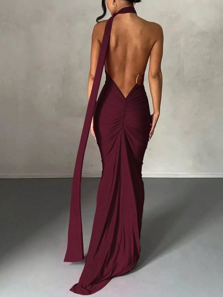 Backless One-Shoulder Bodycon Dress with ruched detailing, asymmetrical neckline, open back design, and elegant floor-length fitted silhouette.