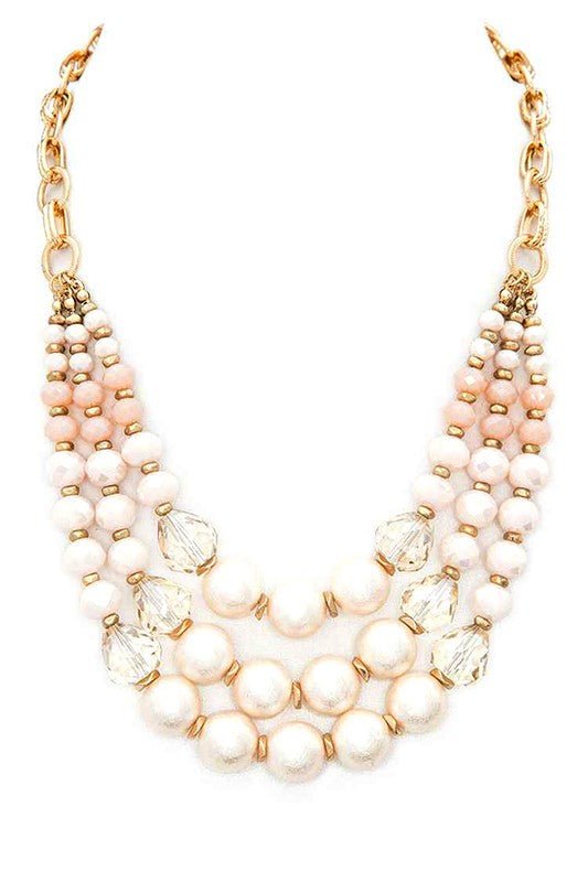 Crystal pearl statement necklace with layered station design, featuring luminous pearls, sparkling crystal accents, and adjustable chain extension
