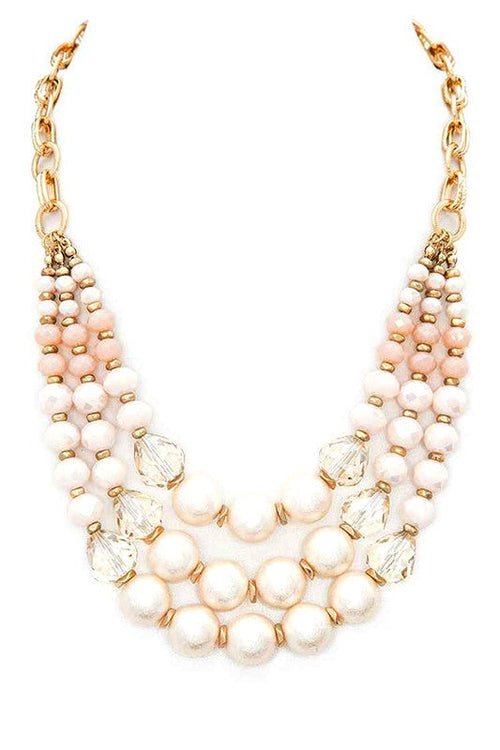 Crystal pearl statement necklace with layered station design, featuring luminous pearls, sparkling crystal accents, and adjustable chain extension