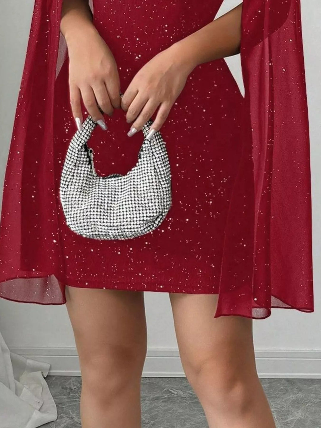 Glitter Cape Sleeve Mini Dress featuring shimmering fabric, elegant cape sleeves, subtle front cutout detail, and fitted bodycon mini silhouette.