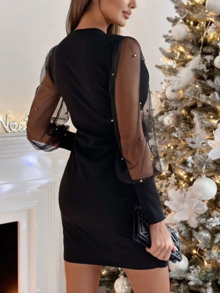 Floral Applique Bodycon Dress with sheer mesh sleeves, ruched detailing, delicate floral appliqué accents, and fitted curve-enhancing silhouette.