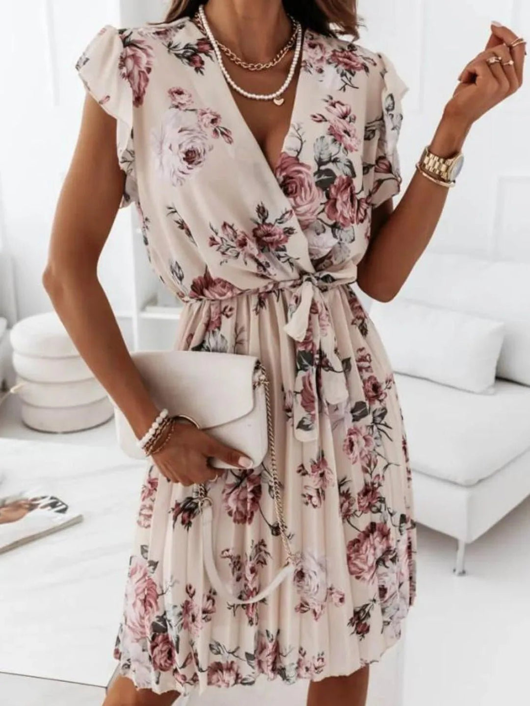 Floral Surplice Ruffle Dress with cap sleeves, wrap-style neckline, tie waist detail, and layered ruffle accents in soft floral print