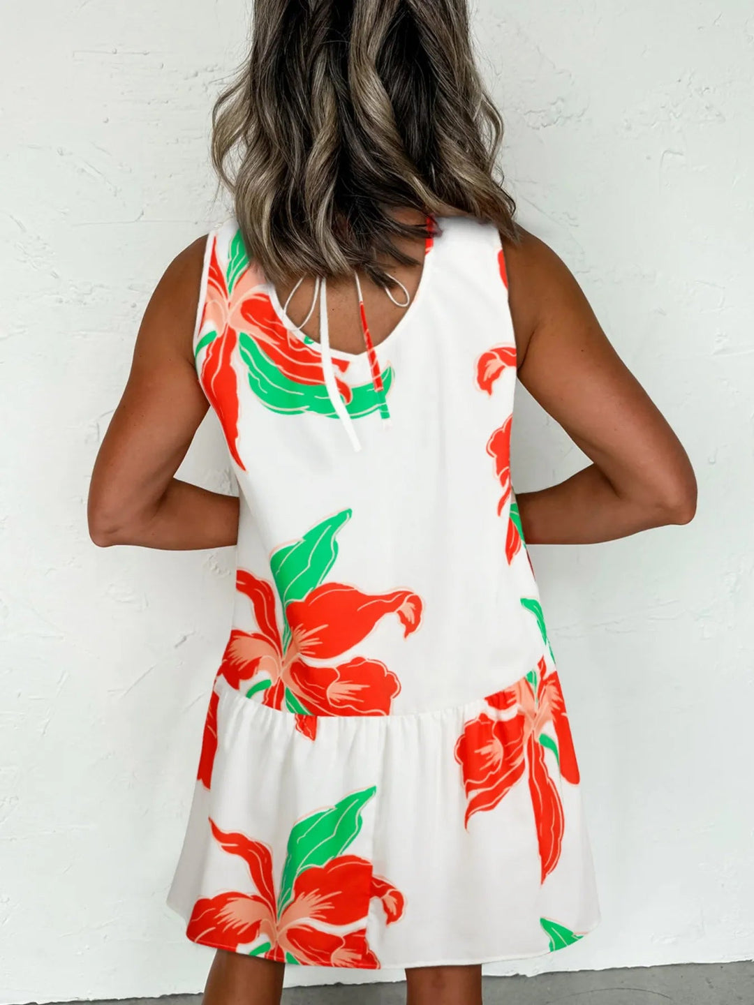 Floral Tie Neck Sundress with ruffled trim, sleeveless cut, and flowy silhouette in lightweight floral print fabric.