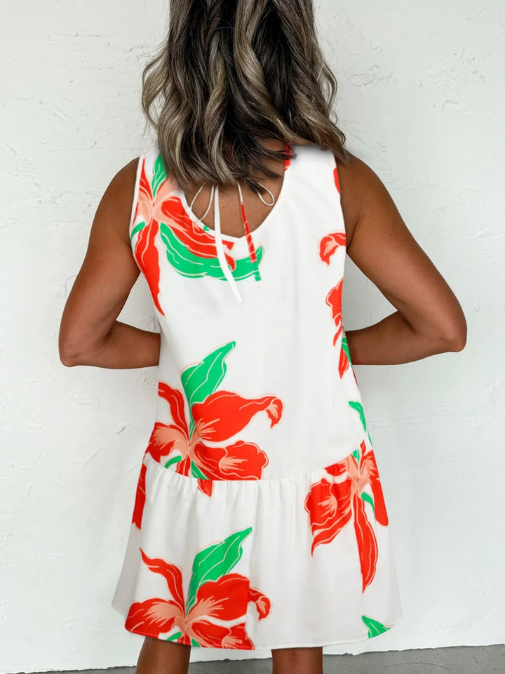 Floral Tie Neck Sundress with ruffled trim, sleeveless cut, and flowy silhouette in lightweight floral print fabric.