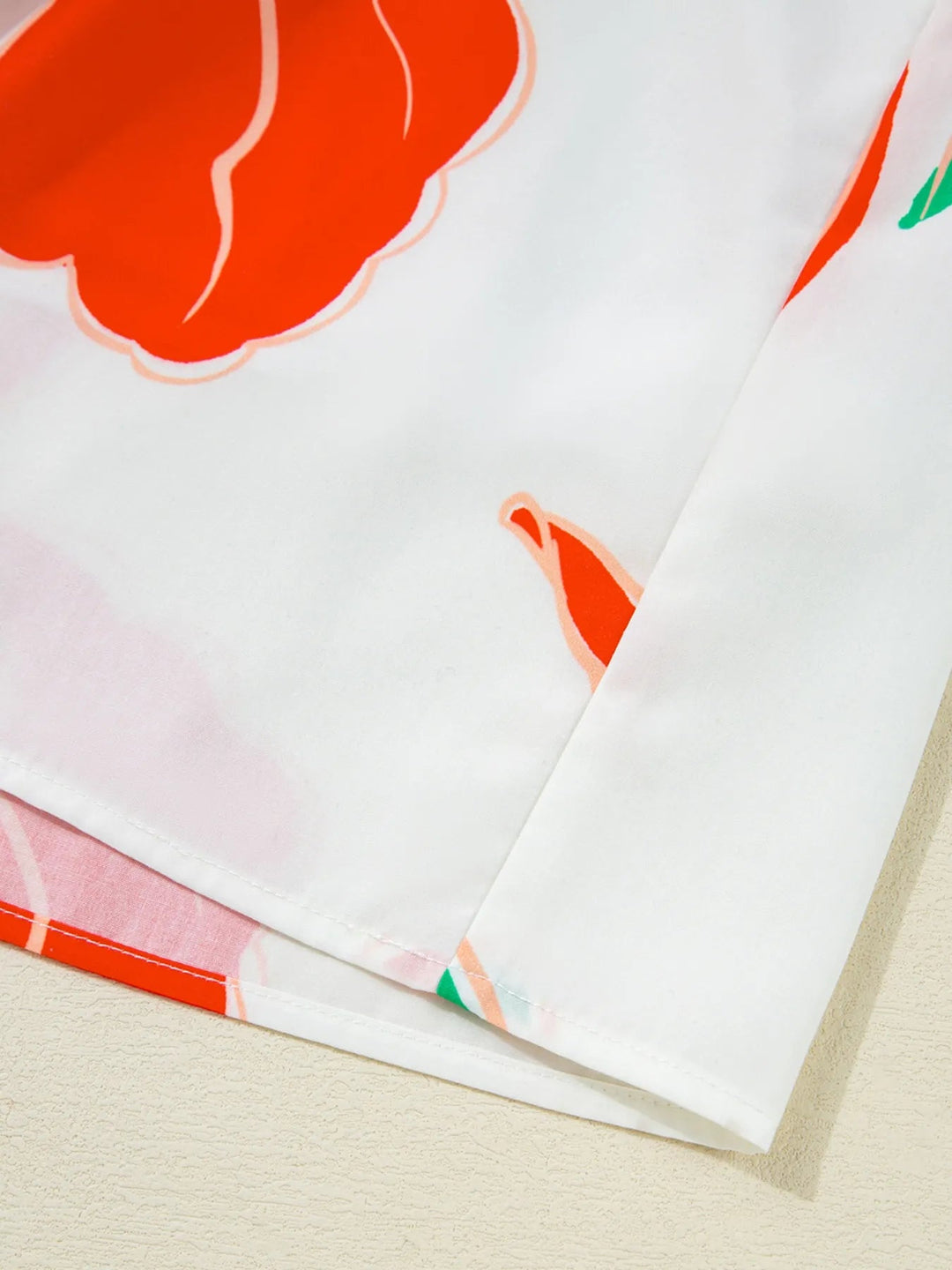 Floral Tie Neck Sundress with ruffled trim, sleeveless cut, and flowy silhouette in lightweight floral print fabric.