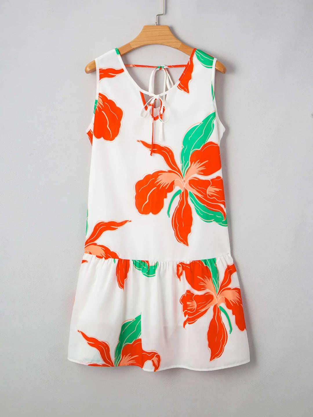 Floral Tie Neck Sundress with ruffled trim, sleeveless cut, and flowy silhouette in lightweight floral print fabric.