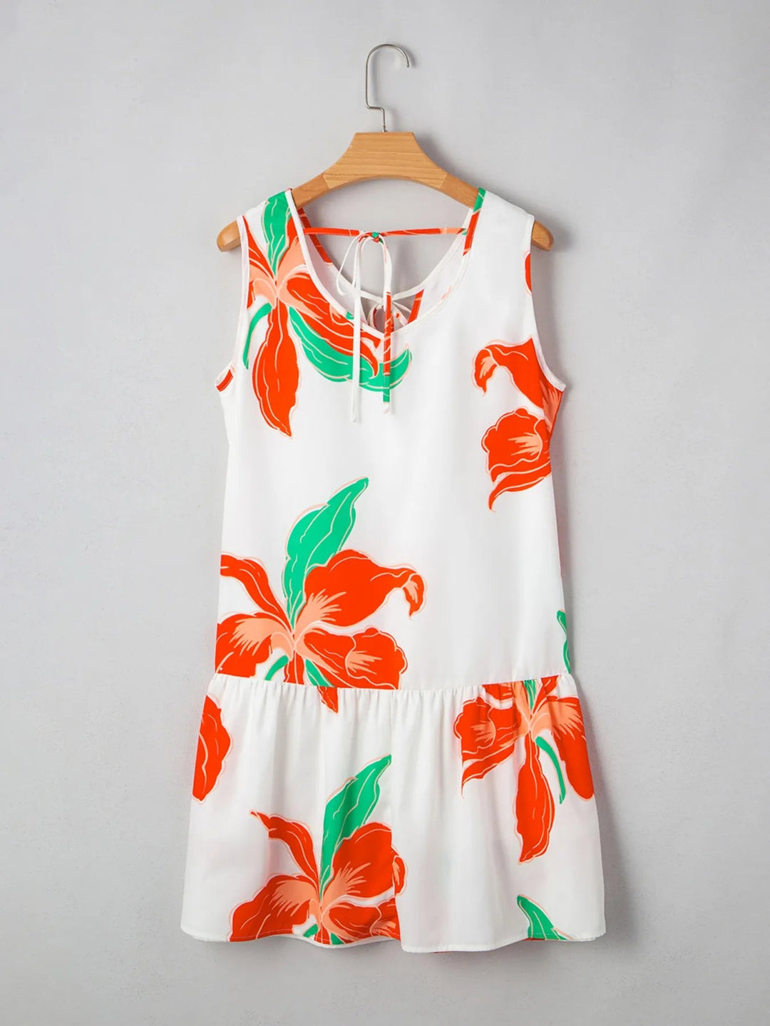 Floral Tie Neck Sundress with ruffled trim, sleeveless cut, and flowy silhouette in lightweight floral print fabric.