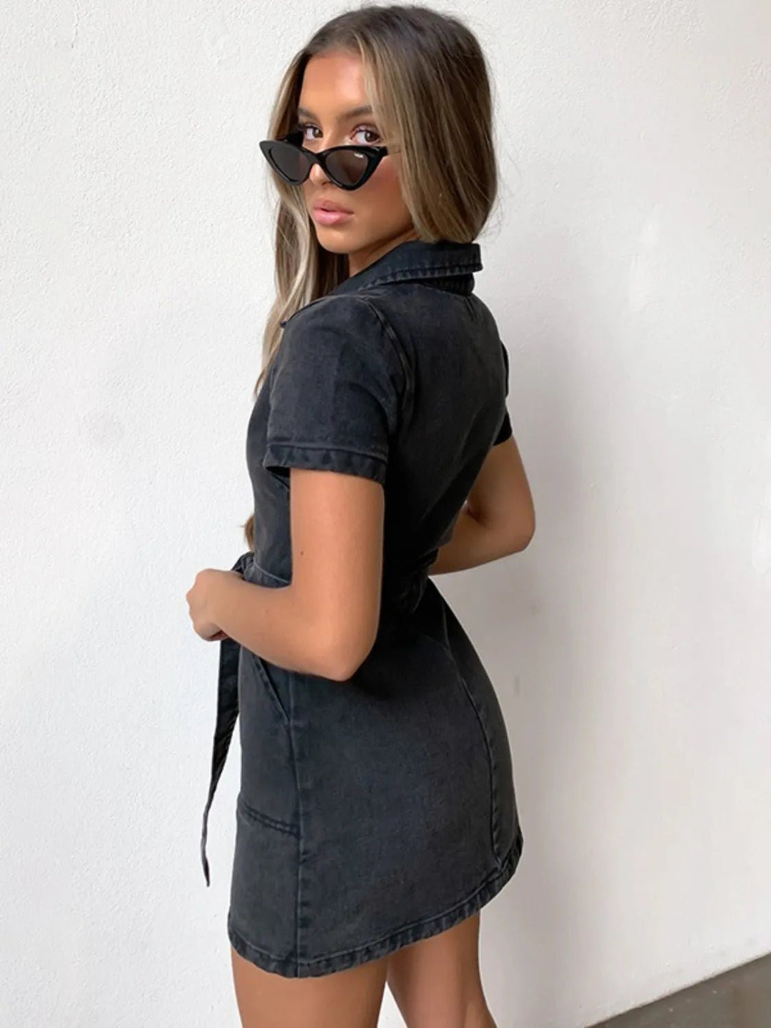Plus Size Zip Front Denim Dress with short sleeves, adjustable tie waist, functional pockets, and flattering structured silhouette