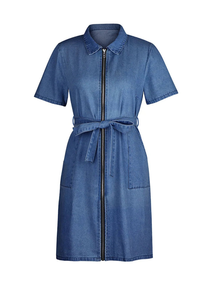 Plus Size Zip Front Denim Dress with short sleeves, adjustable tie waist, functional pockets, and flattering structured silhouette