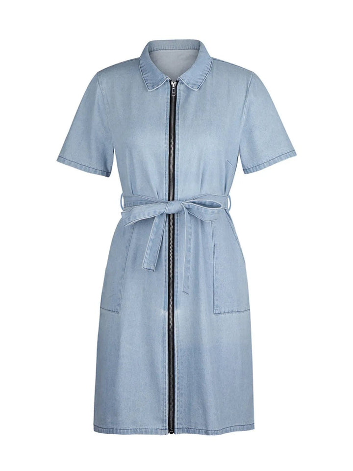 Plus Size Zip Front Denim Dress with short sleeves, adjustable tie waist, functional pockets, and flattering structured silhouette