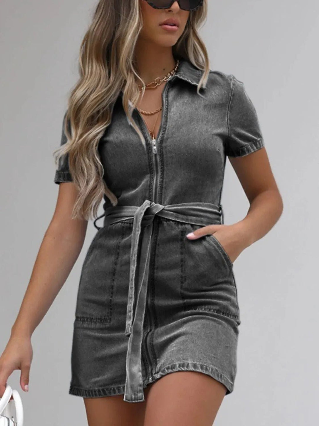 Plus Size Zip Front Denim Dress with short sleeves, adjustable tie waist, functional pockets, and flattering structured silhouette
