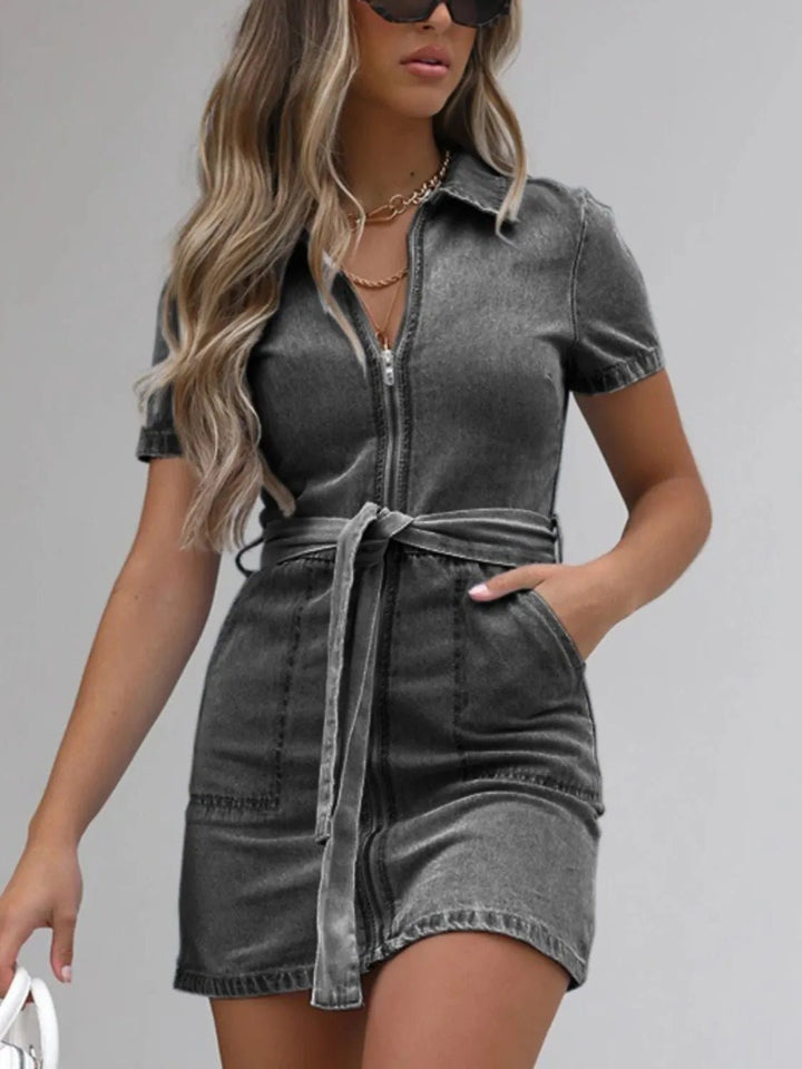 Plus Size Zip Front Denim Dress with short sleeves, adjustable tie waist, functional pockets, and flattering structured silhouette