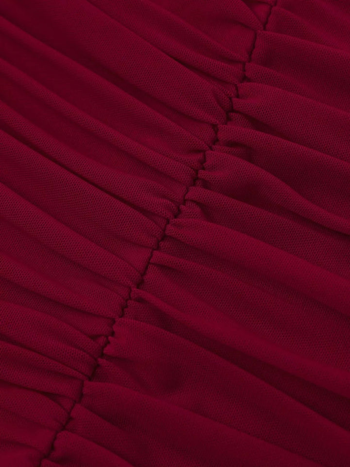 Halter Neck Ruched Slit Dress featuring sculpted ruched bodice, sheer mesh detail, high side slit, adjustable waist tie, and fitted floor-length maxi silhouette.