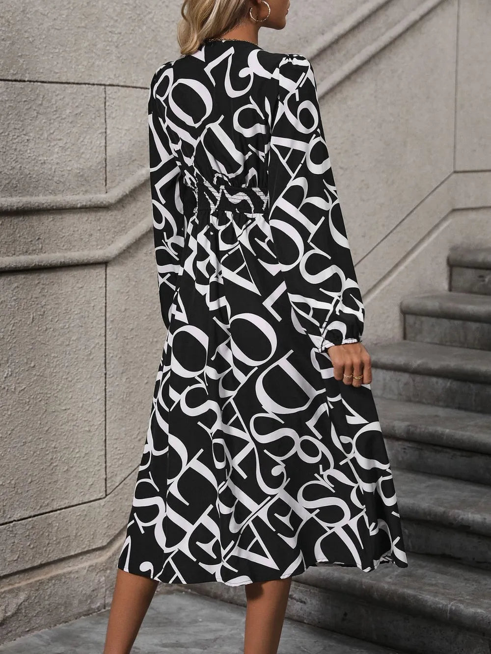 Printed V-Neck Midi Dress with long sleeves, buttoned front detail, and flowing midi-length silhouette in opaque fabric.