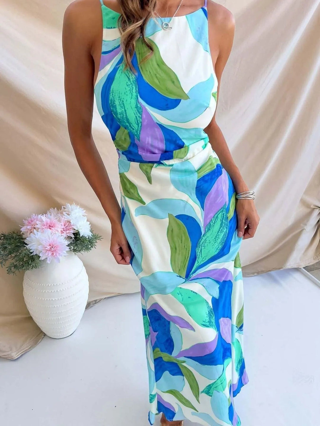 Printed Backless Maxi Dress with sleeveless design, flowing full-length silhouette, and elegant open back detail