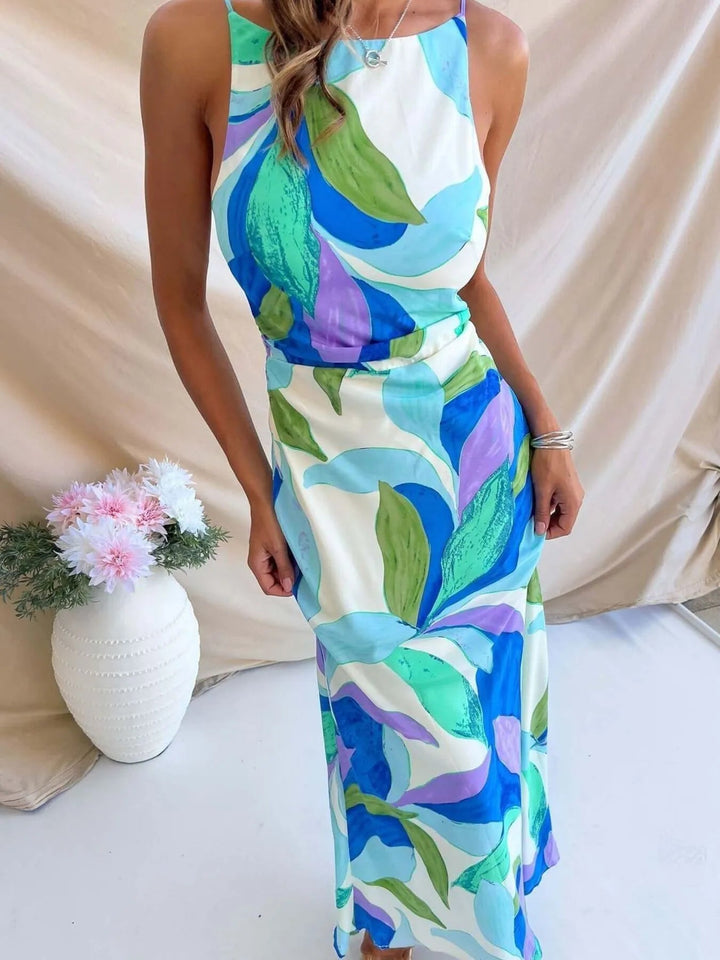 Printed Backless Maxi Dress with sleeveless design, flowing full-length silhouette, and elegant open back detail