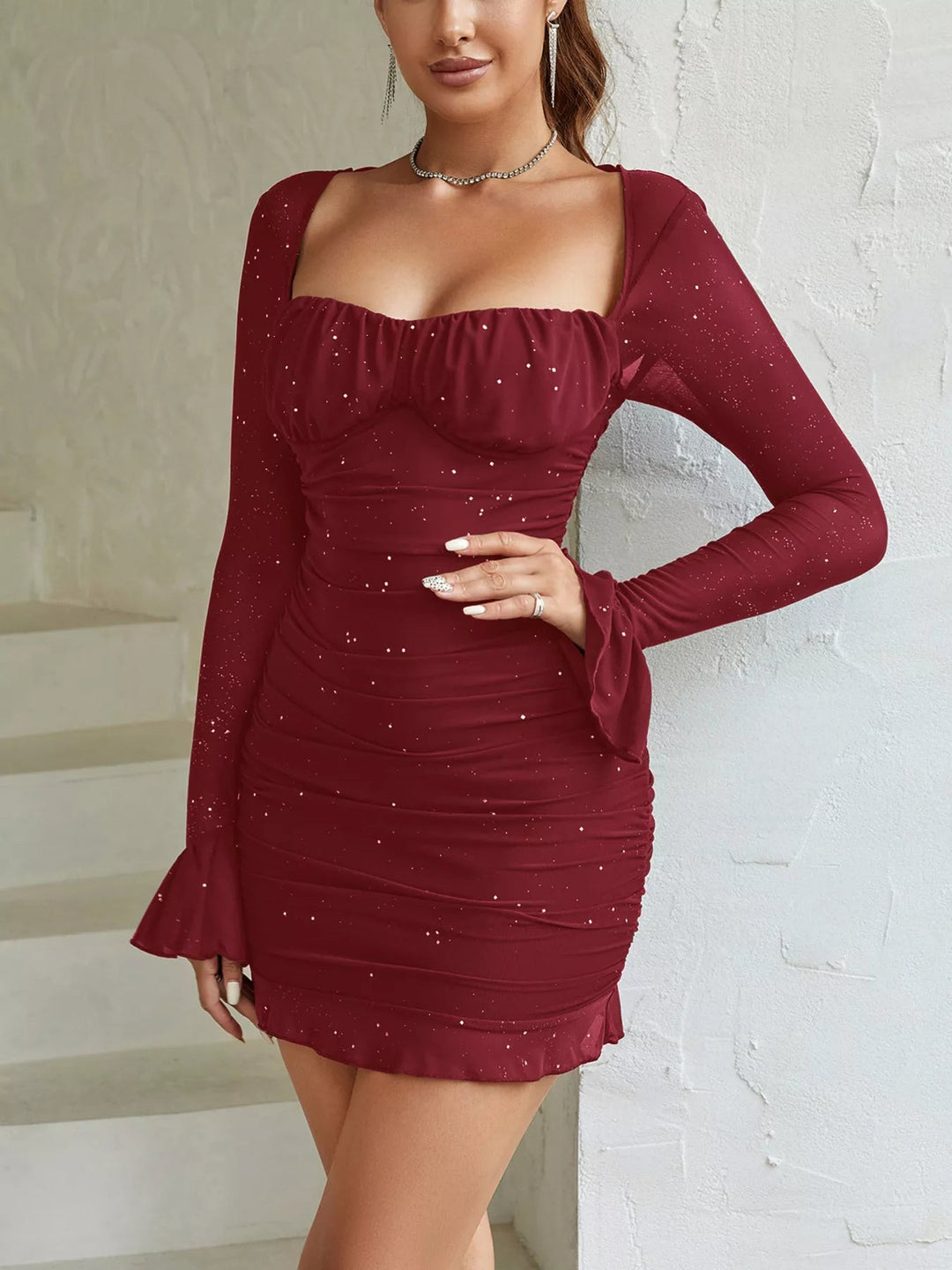 Ruched Glitter Bodycon Dress with sheer mesh panels, sparkling glitter fabric, fitted mini silhouette, and zip-back closure detail.