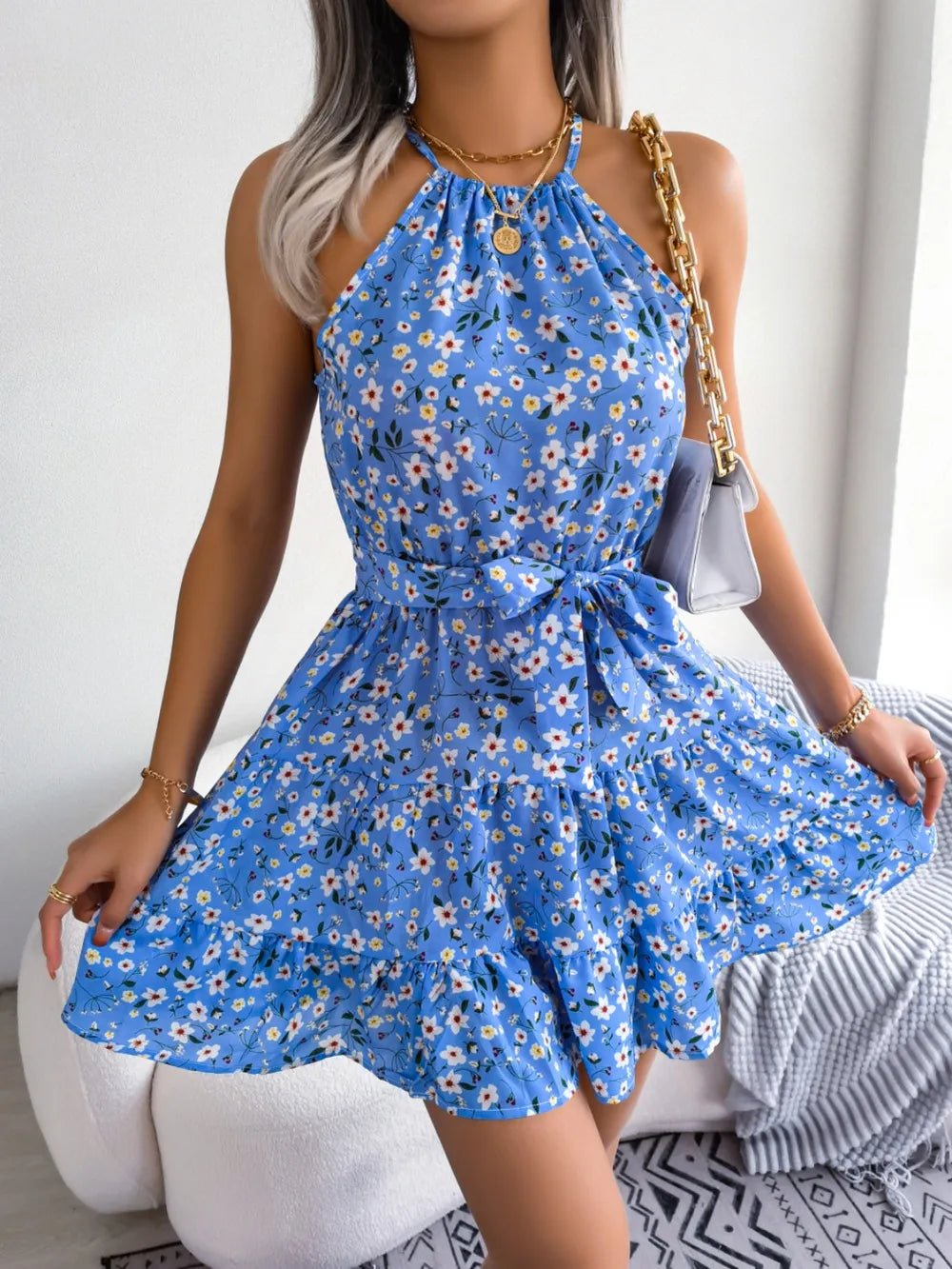 Printed Grecian Mini Dress with tied neckline, bold allover print, sleeveless silhouette, and mini-length hemline.
