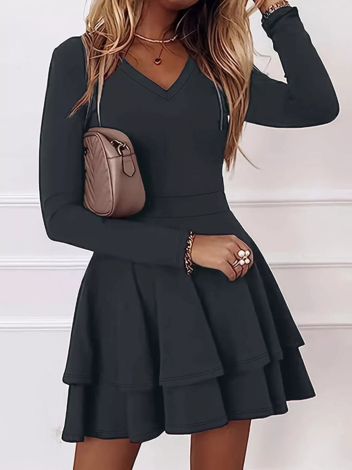 V-Neck Ruffle Mini Dress with layered tiers and flowing silhouette in soft stretch fabric, featuring a flattering V neckline