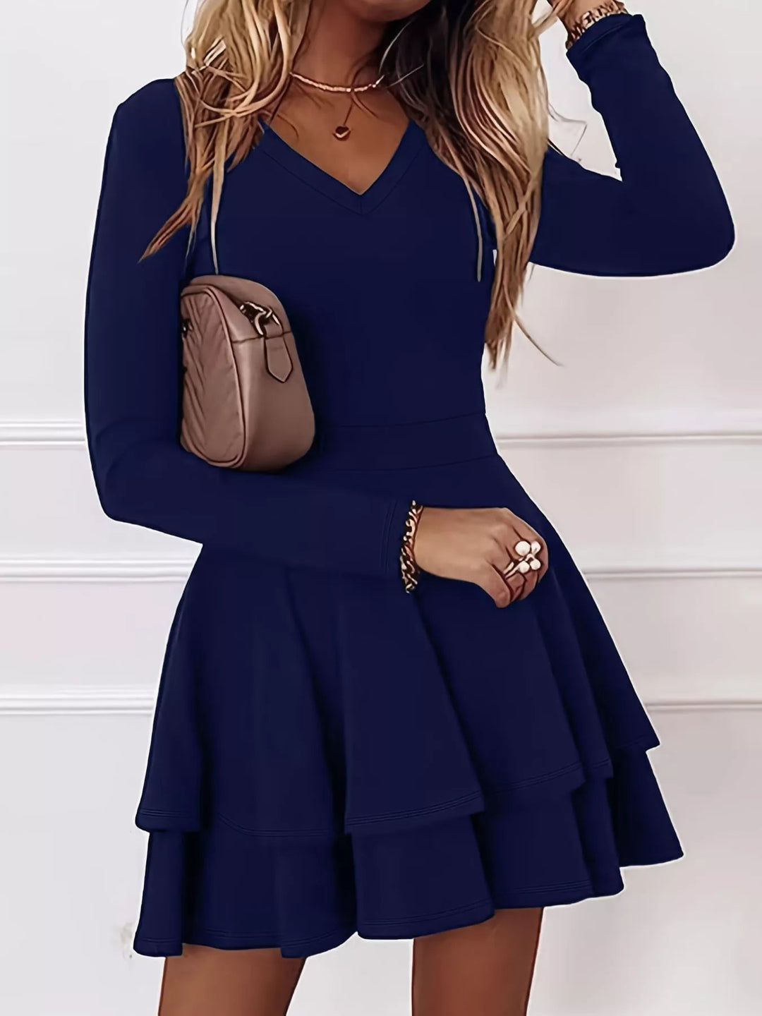 V-Neck Ruffle Mini Dress with layered tiers and flowing silhouette in soft stretch fabric, featuring a flattering V neckline