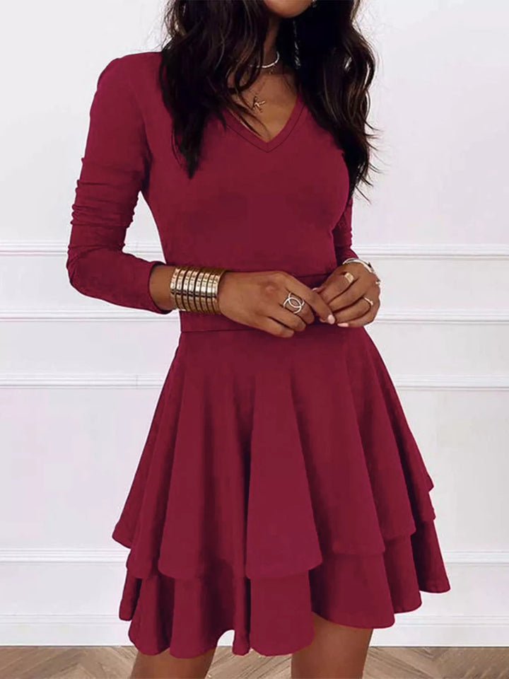V-Neck Ruffle Mini Dress with layered tiers and flowing silhouette in soft stretch fabric, featuring a flattering V neckline