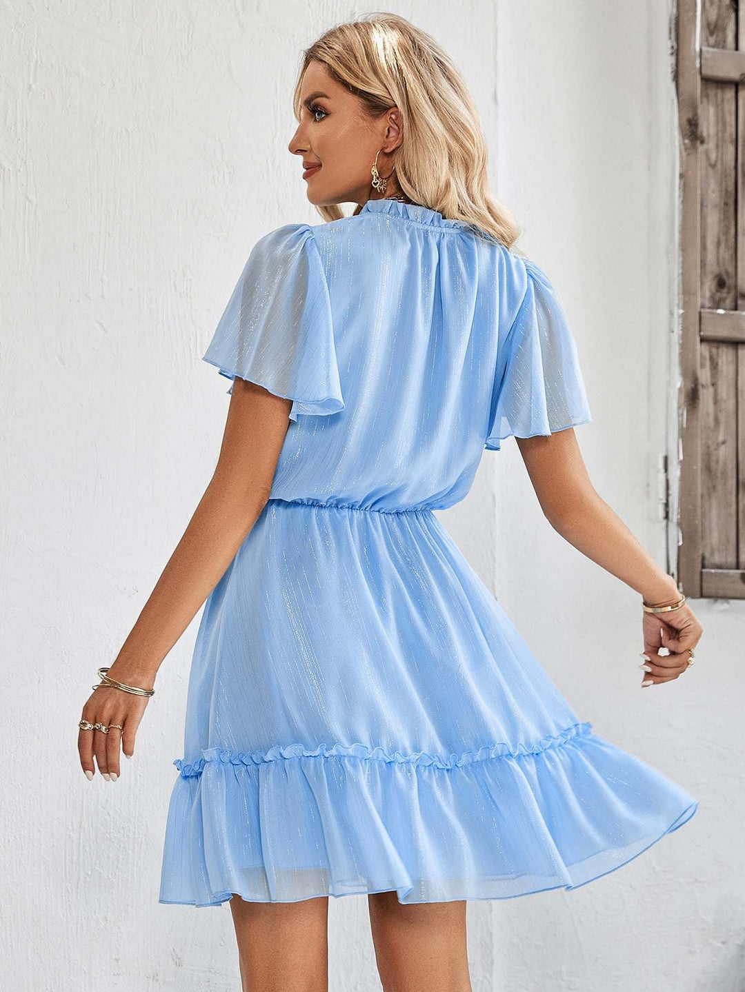Women’s v-neck ruffle hem mini dress in a solid color featuring a flowy silhouette and adjustable waist tie