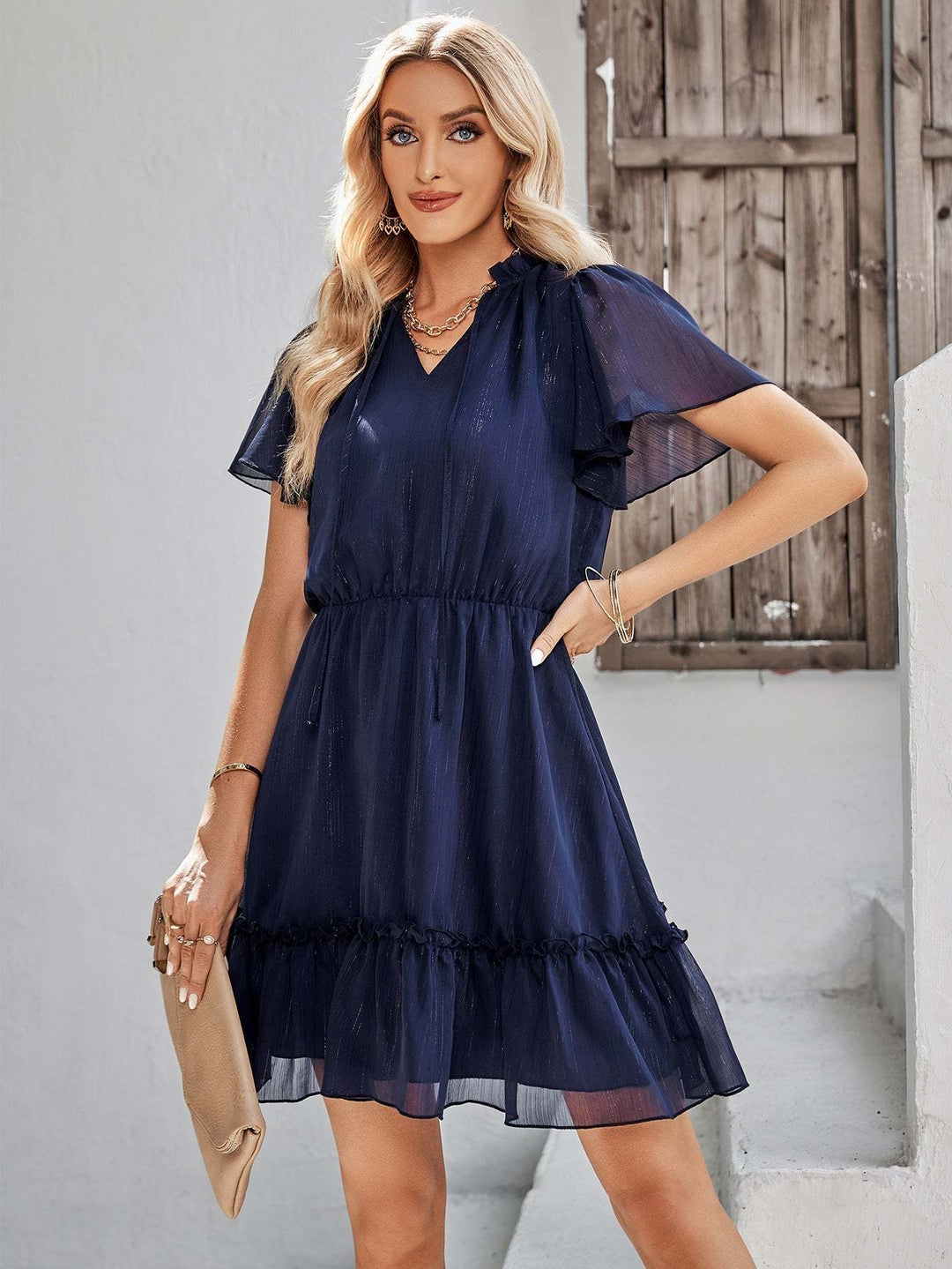 Women’s v-neck ruffle hem mini dress in a solid color featuring a flowy silhouette and adjustable waist tie