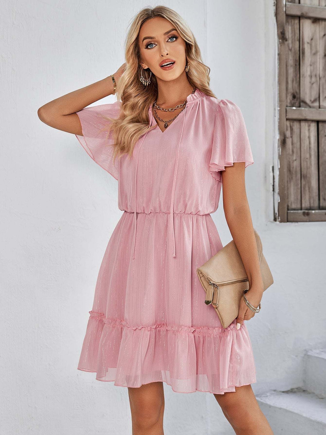 Women’s v-neck ruffle hem mini dress in a solid color featuring a flowy silhouette and adjustable waist tie